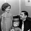 Shirley Temple and composer Harry Revel with her Lenci Bellhop doll on the set of Stowaway, 1936