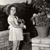 Shirley Temple at home with her dog Ching Ching, September 1937