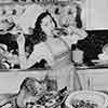 Shirley Temple at her Brentwood home cooking a Thanksgiving turkey, 1941