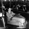 Photo of John Derek at an amusement park, November 1953