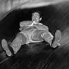 Photo of John Derek at an amusement park, November 1953