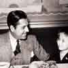 Warner Baxter and Shirley Temple at the Fox Commissary during filming of Stand Up And Cheer, 1934