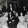 Back row: Frank Morgan, Melvyn Douglas, Charles Laughton, Dick Powell, and Reginald Owen. Seated: Madeleine Carroll, Samuel Goldwyn, Clark Gable, Carole Lombard, Shirley Temple, and Myrna Loy. Greek War Relief Benefit at Grauman's, February 8, 1941