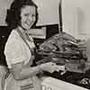 Shirley Temple at her Brentwood home cooking a Thanksgiving turkey, 1941