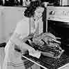 Shirley Temple at her Brentwood home cooking a Thanksgiving turkey, 1941