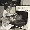 Shirley Temple at her Brentwood home cooking a Thanksgiving turkey, 1941